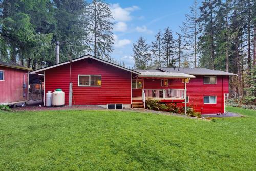 a red house with a yard in front of it at Clearview Forest Retreat in Snohomish
