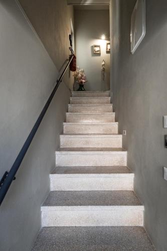a stairway with a vase of flowers at Dea's Rooms in Noto