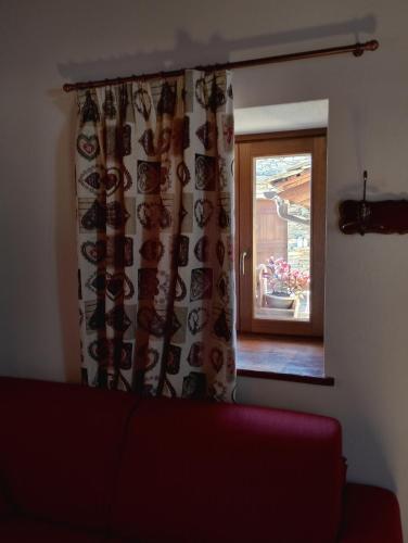 a living room with a couch and a window at Rifugio Alpino Baudinet - Trek&Relax in Chiusa di Pesio