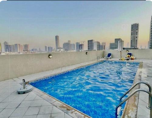 a large swimming pool on the roof of a building at 1BR Apartment with Private Jacuzzi in JVC - JLiving in Dubai