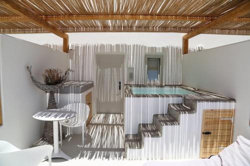 a swimming pool in a house with a glass floor at Rocabella Santorini Hotel & Spa in Imerovigli