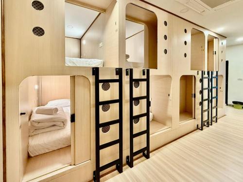 a room with a bed and a room with mirrors at J Park Pakchong in Ban Sao Thong