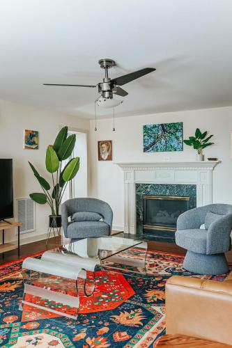a living room with two chairs and a fireplace at North Central Loft in Staunton