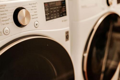 a white microwave oven sitting next to a washing machine at North Central Loft in Staunton