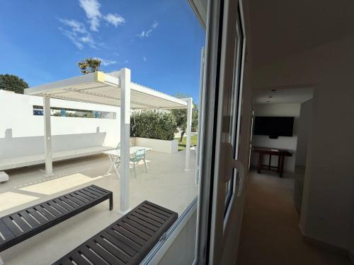 a view of a balcony with a table and a television at Buona Onda Apartments in Siracusa