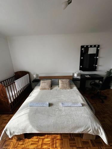 a bedroom with a large bed with two pillows at TAMARIS Apartment in Subotica