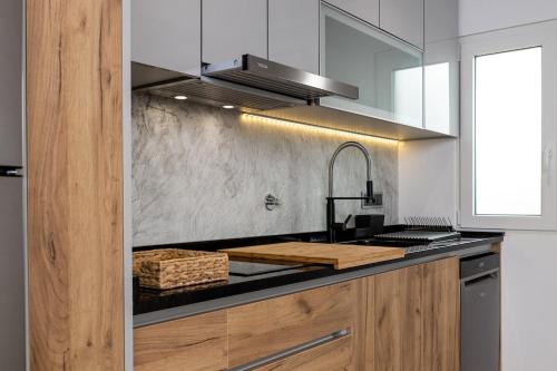 a kitchen with a sink and a counter top at Sunset House - by Monte das Alpenduradas in Zambujeira do Mar