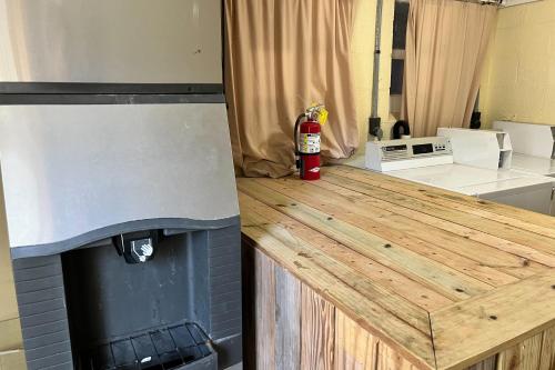 a kitchen with a wooden counter top with a fire extinguisher at Georgianne Suite Five in Tybee Island