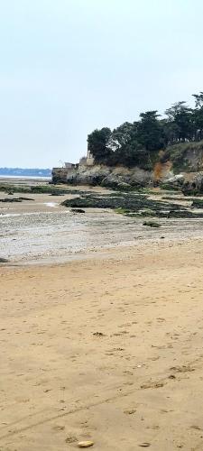 a beach with a frisbee in the sand at Appartement vue mer in La Bernerie-en-Retz