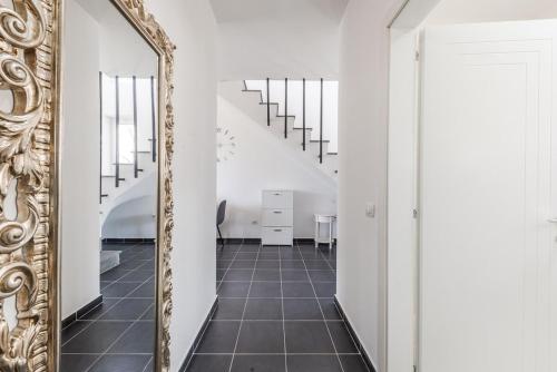 a hallway with a mirror and a staircase at Coastal Haven Talea in Tale