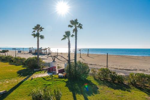 a view of a beach with palm trees and the ocean at Coastal Haven Talea in Tale