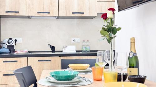 une cuisine avec une table et une rose dans un vase dans l'établissement Casa Serenissima by Ca-Sa Check, à Chioggia