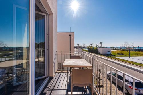 a balcony with a table and chairs and a view at Coastal Haven Talea in Tale