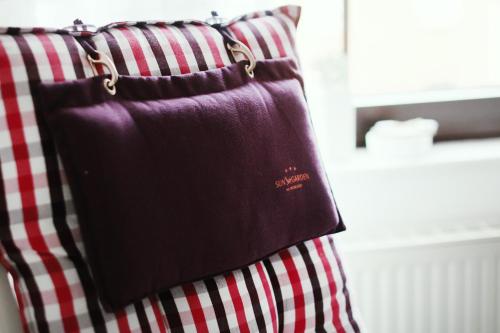 a purple bag hanging on a red and white pillow at Jül Boardinghouse in Jülich