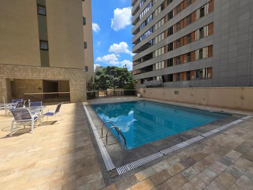 a swimming pool on the side of a building at Apart Hotel Volpi 101 - Conforto & Comodidade in Belo Horizonte