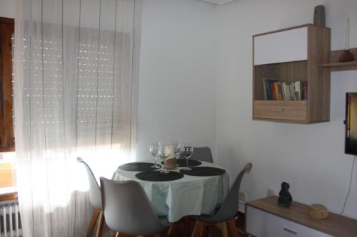 a dining room table with wine glasses on it at Una ciudad por descubrir in Valencia de Don Juan