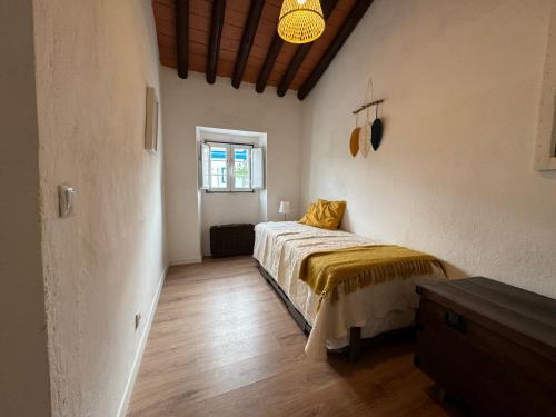 a bedroom with a bed and a window in it at Casa Azul Barbacena in Barbacena