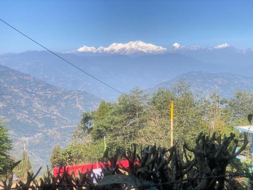 a view of a mountain range with mountains in the background at Kanchenjunga View Homestay in Sukhia Pokhari