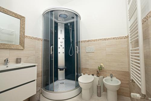 a bathroom with a shower and a toilet and a sink at Guest House Genova Holiday in Genova