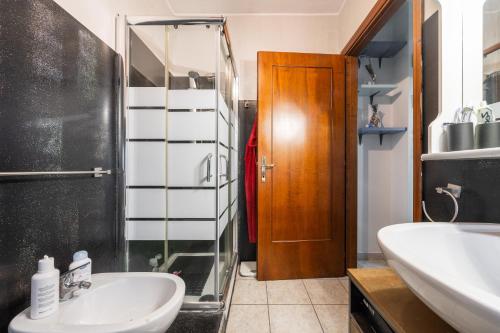 a bathroom with a sink and a shower and a mirror at Gio's Gio's House in Monserrato