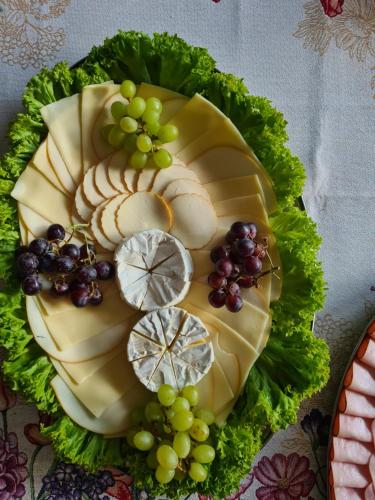 a plate of cheese and grapes on a table at Pension St. Maria in Staré Hory