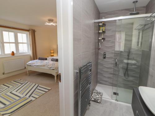 a bathroom with a shower and a sink at 4 Centurion Rise in Penrith
