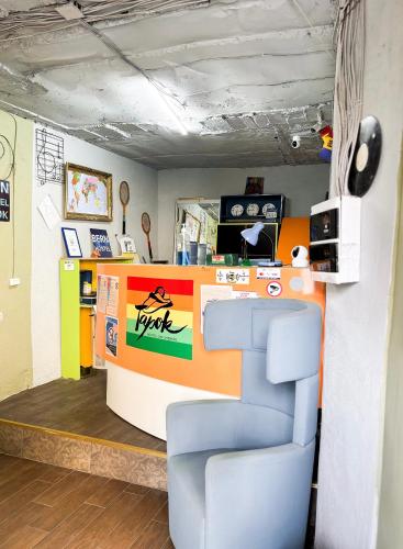 a store with a colorful counter and a chair at Mouse House in Chişinău