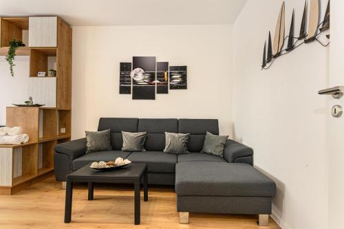 a living room with a couch and a table at Luxury Landing Apartments Complex Qualis Brasov in Braşov