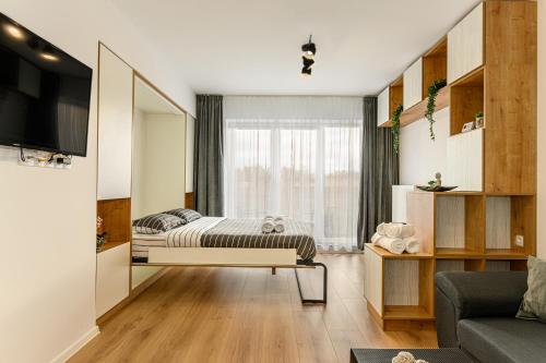 a bedroom with a bed and a large window at Luxury Landing Apartments Complex Qualis Brasov in Braşov