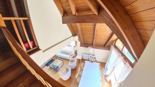 an overhead view of a living room with a wooden ceiling at Los Altos de Escarrilla - tucasaenlospirineos in Escarrilla