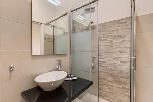 a bathroom with a sink and a shower at YH SUITE 131 in Rome