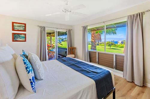 a bedroom with a bed and a large window at Kaanapali Plantation 6 in Lahaina
