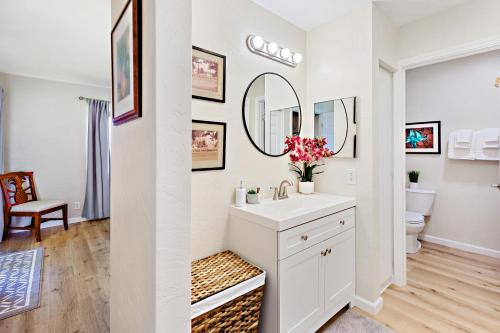 a white bathroom with a sink and a toilet at Kaanapali Plantation 6 in Lahaina