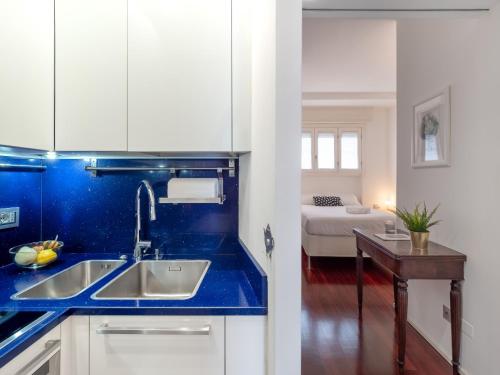 a kitchen with a sink and a blue counter top at Residence Vigliani in Milan