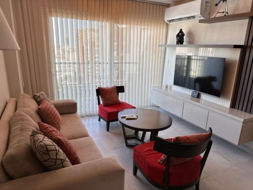 Una sala de estar con un sofá y un televisor. en G12 - Bon Repos, en San Miguel de Tucumán