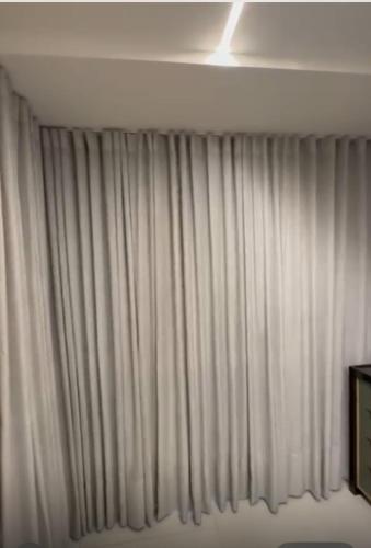 a window with white curtains in a room at Gerizim in Vila Velha