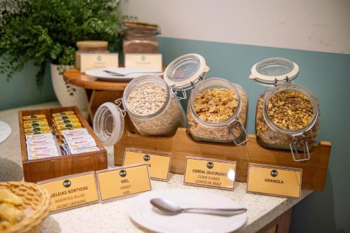 a table with several jars of oatmeal and other food at B&B HOTEL Rio Copacabana Forte in Rio de Janeiro