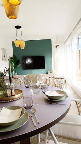 a dining room with a table with plates and wine glasses at SA Exklusives Stadtapartment mit 3 SZ in Warburg