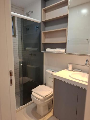 a bathroom with a shower and a toilet and a sink at Donatos home in Vila Velha
