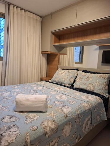 a bedroom with a large bed with a pillow on it at Donatos home in Vila Velha