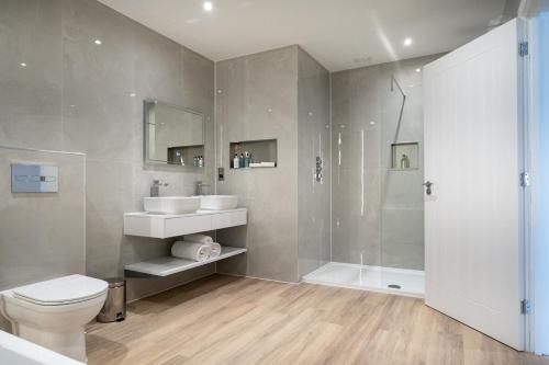a bathroom with a toilet and a sink and a shower at Dale Hill Hotel in Ticehurst