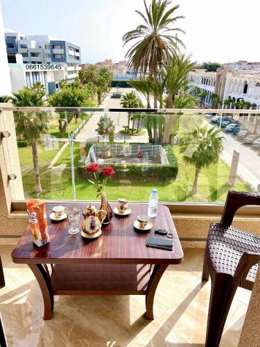 a table with plates of food on top of a balcony at Marchica bay 8 holiday Apartment in Nador