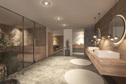 a bathroom with a sink and a mirror at Berghotel Wald & Wiesn in Balderschwang