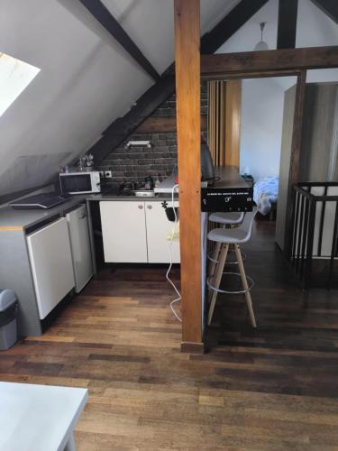 a kitchen with a desk and a table in a room at Appart 3 sous combles in Bray-Dunes