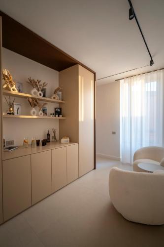 a living room with a couch and a chair at Halo Suite in Naples
