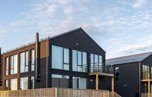 a black house with glass windows on the side of it at Luxury apartment, 8 beds, sauna, 10 min to ski slopes in Idre