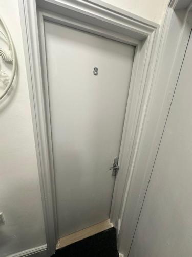 a white door with a silver knob on it at Room 8 NG3 2AZ in Nottingham