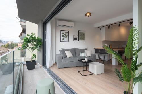 a living room with a couch and a table at Silk Athens Urban Collection in Athens
