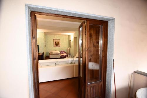 an open door to a bedroom with a bed at Appartamento Vetta Cremolino in Cremolino