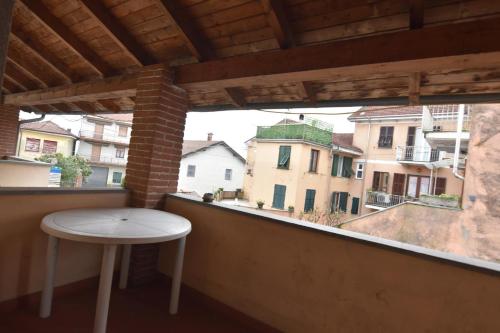 a table and stool on a balcony with a view at Appartamento Vetta Cremolino in Cremolino